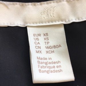 Black jacket with buttons and with a zipper.